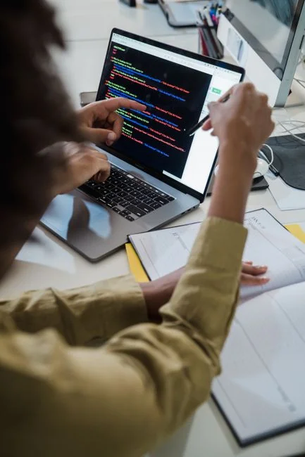 A stylish workspace featuring a laptop and monitors displaying design software.
